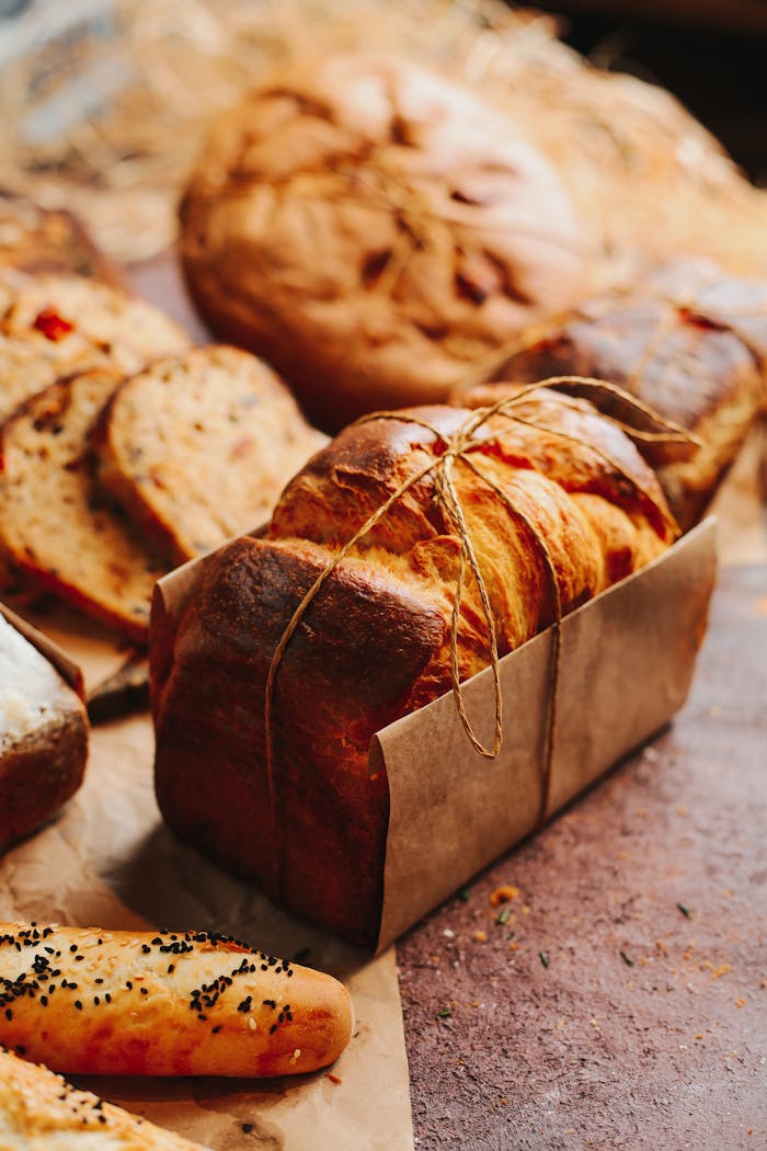 Artisan breads and baguette in a rustic bakery setting, beautifully displayed with natural lighting.